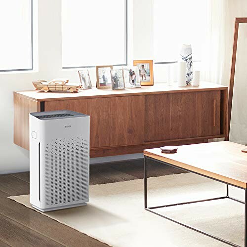 Air purifier in a modern living room with wooden furniture.