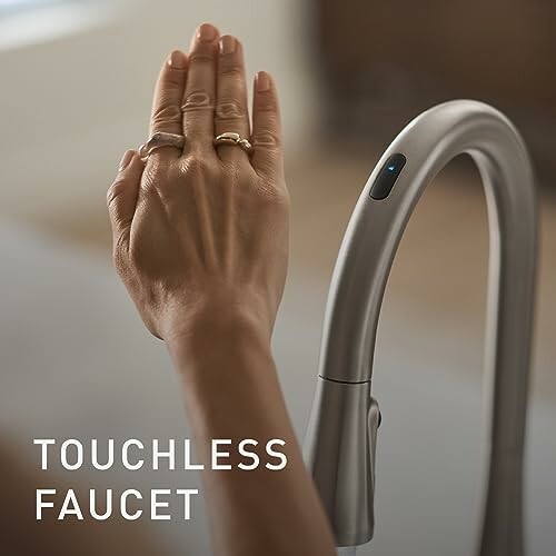 Hand activating a touchless faucet.